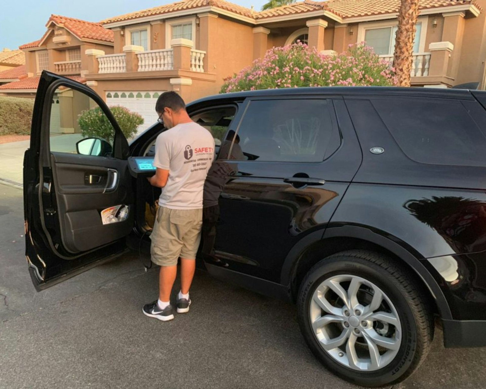 Man opening the door of a black SUV
