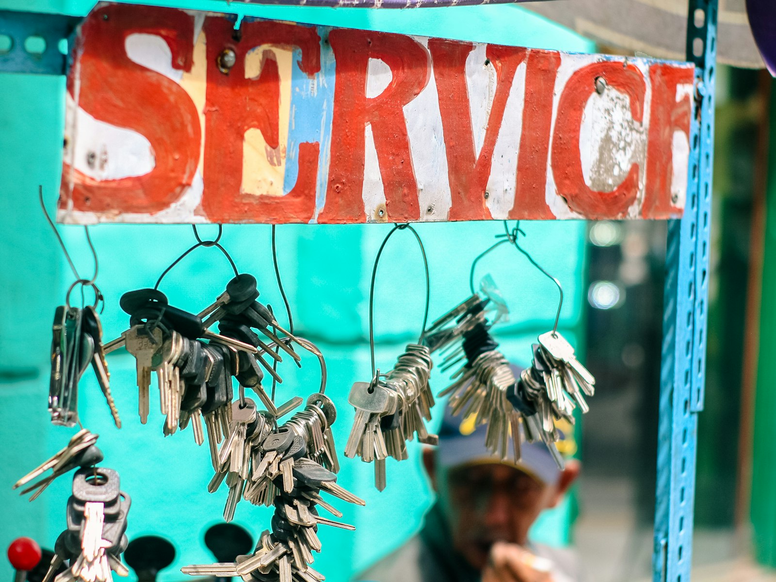 Collection of keys hanging below a service sign